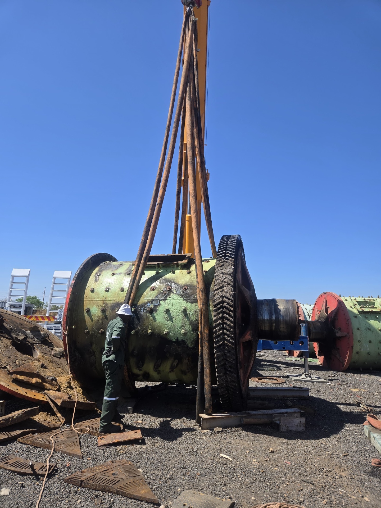 Ball mill being lifted by crane at the equipment yard