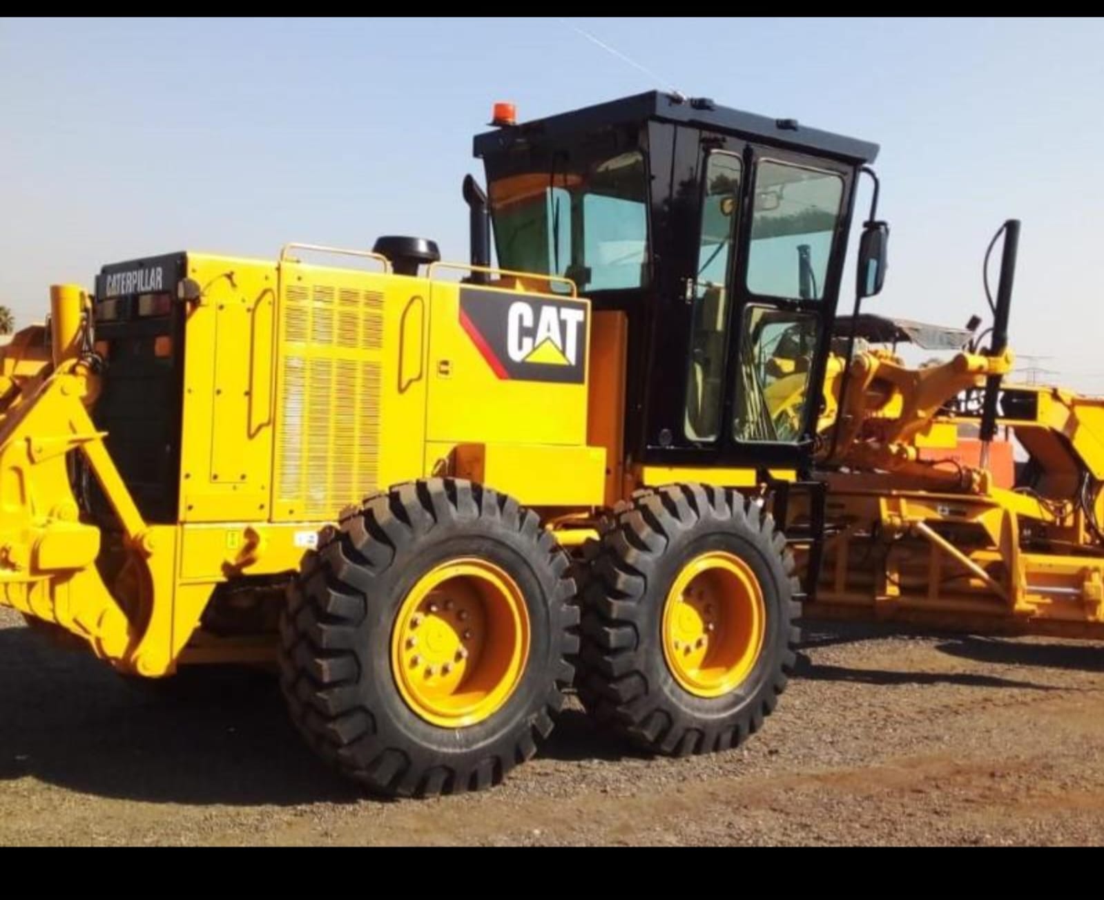 Side view of a Caterpillar motor grader