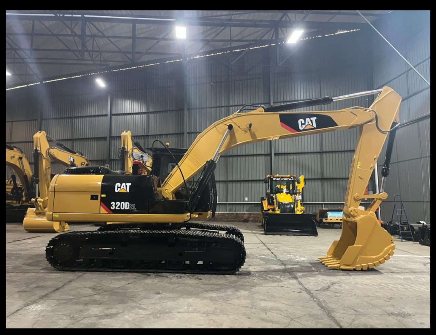 Caterpillar 320D2L excavator inside the equipment warehouse