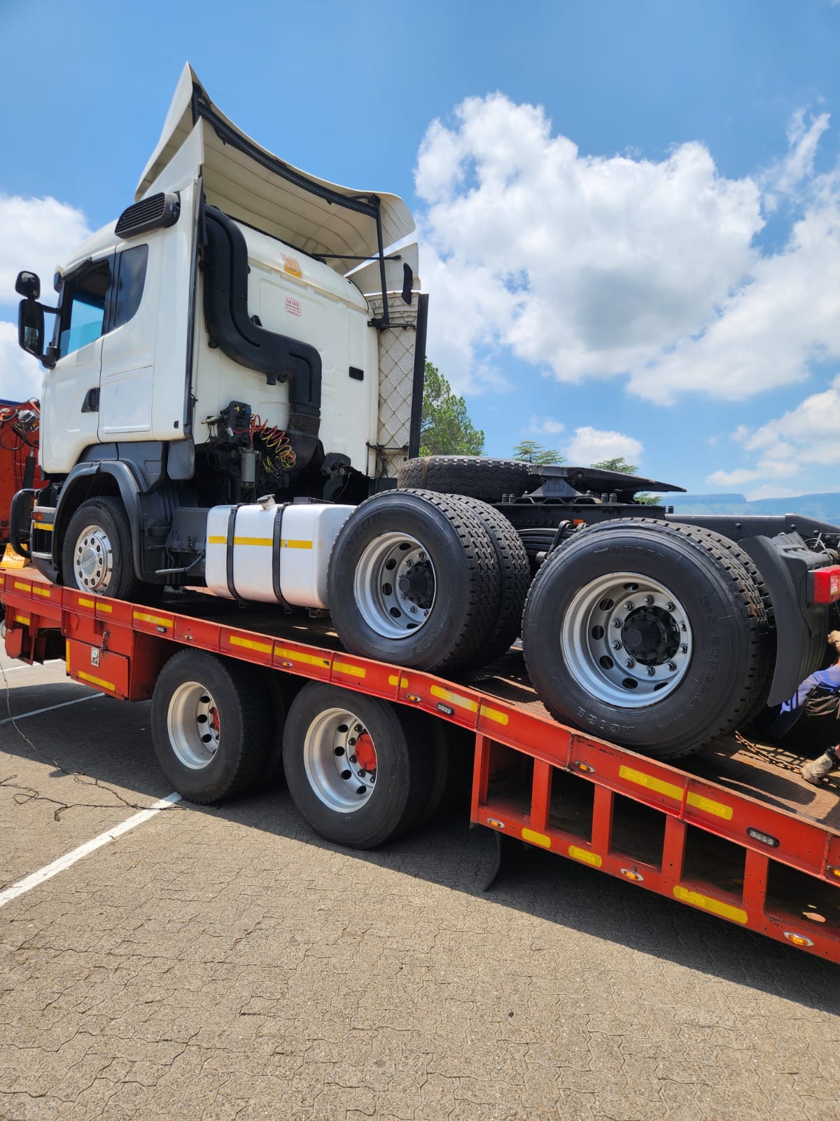 Scania truck tractor secured on a lowbed carrier