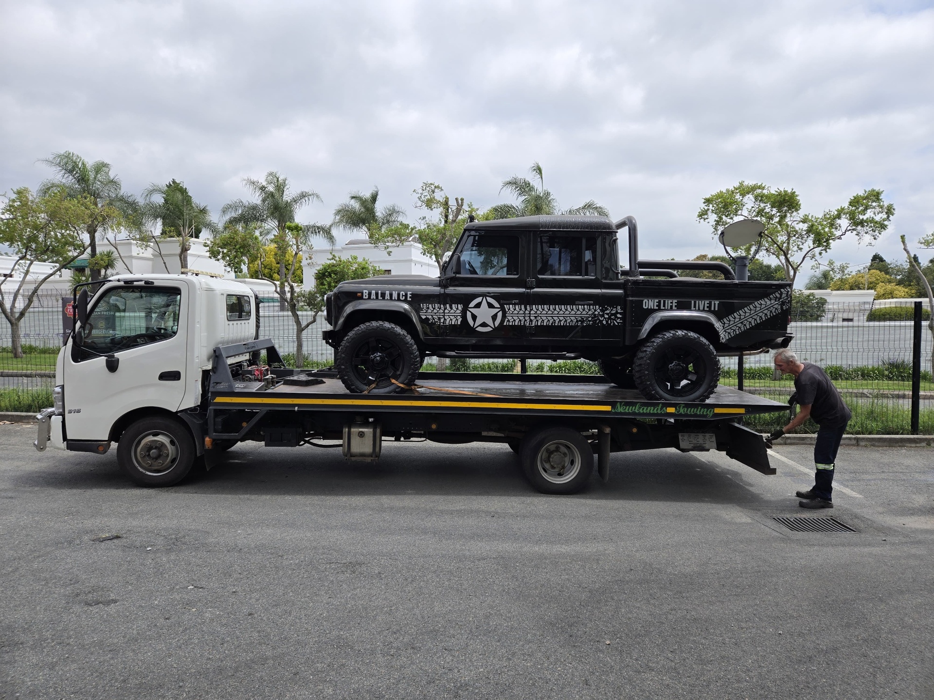 Land Rover Defender loaded on a flatbed for transport
