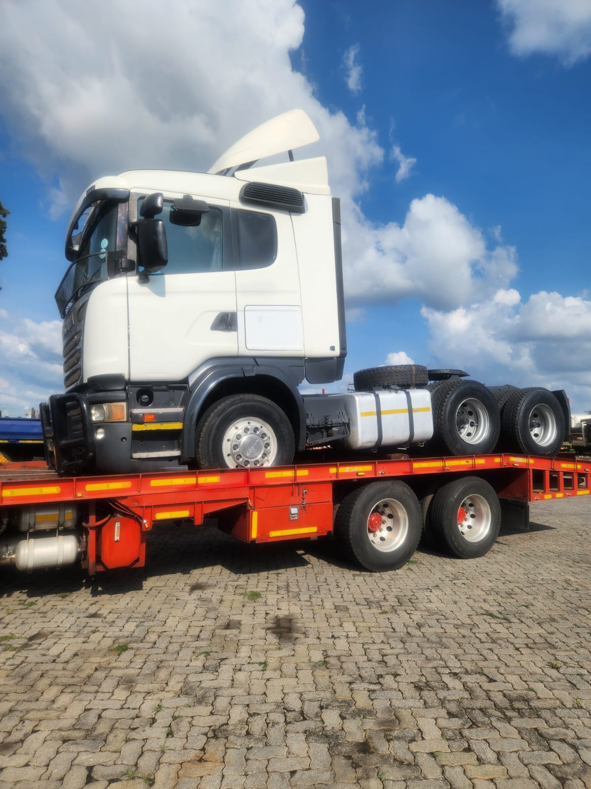 Scania truck horse loaded on a flatbed trailer for export