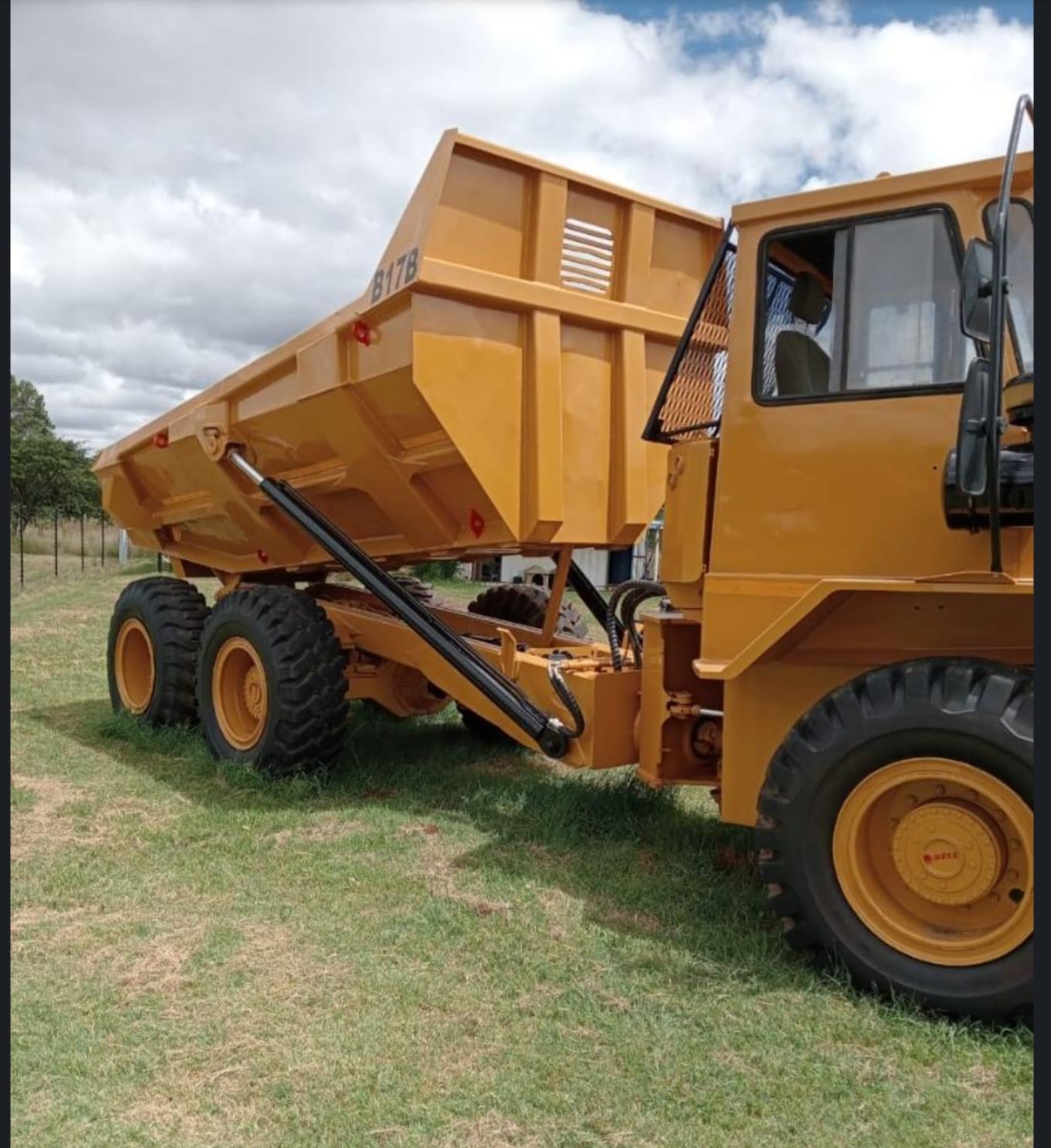 Side view of a Bell B17B dump truck tipping