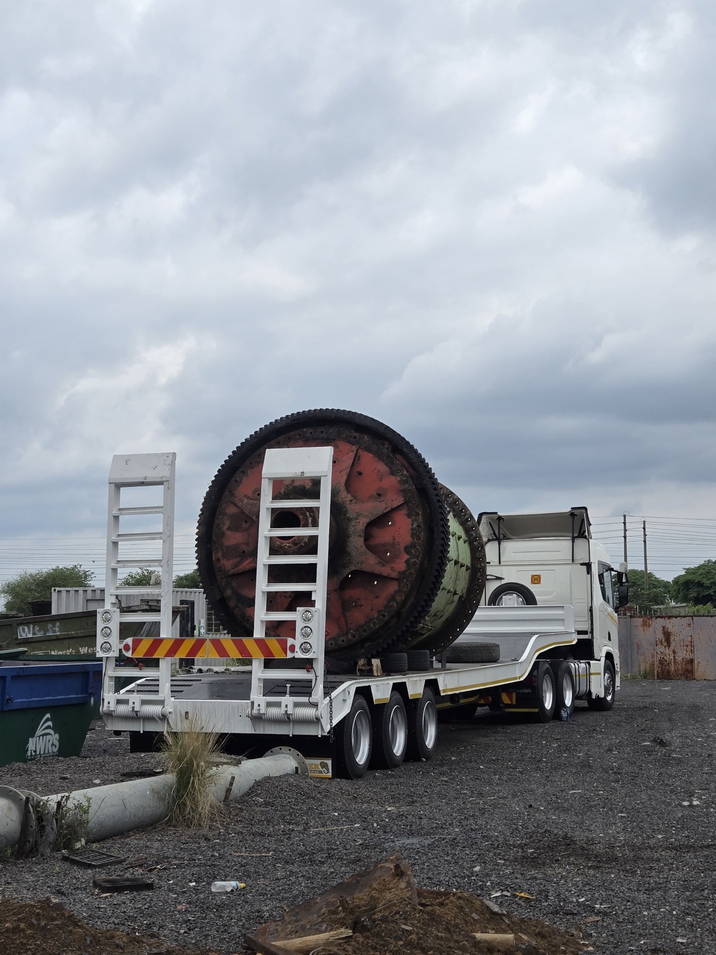 Ball mill secured on a low-bed trailer behind a Scania truck