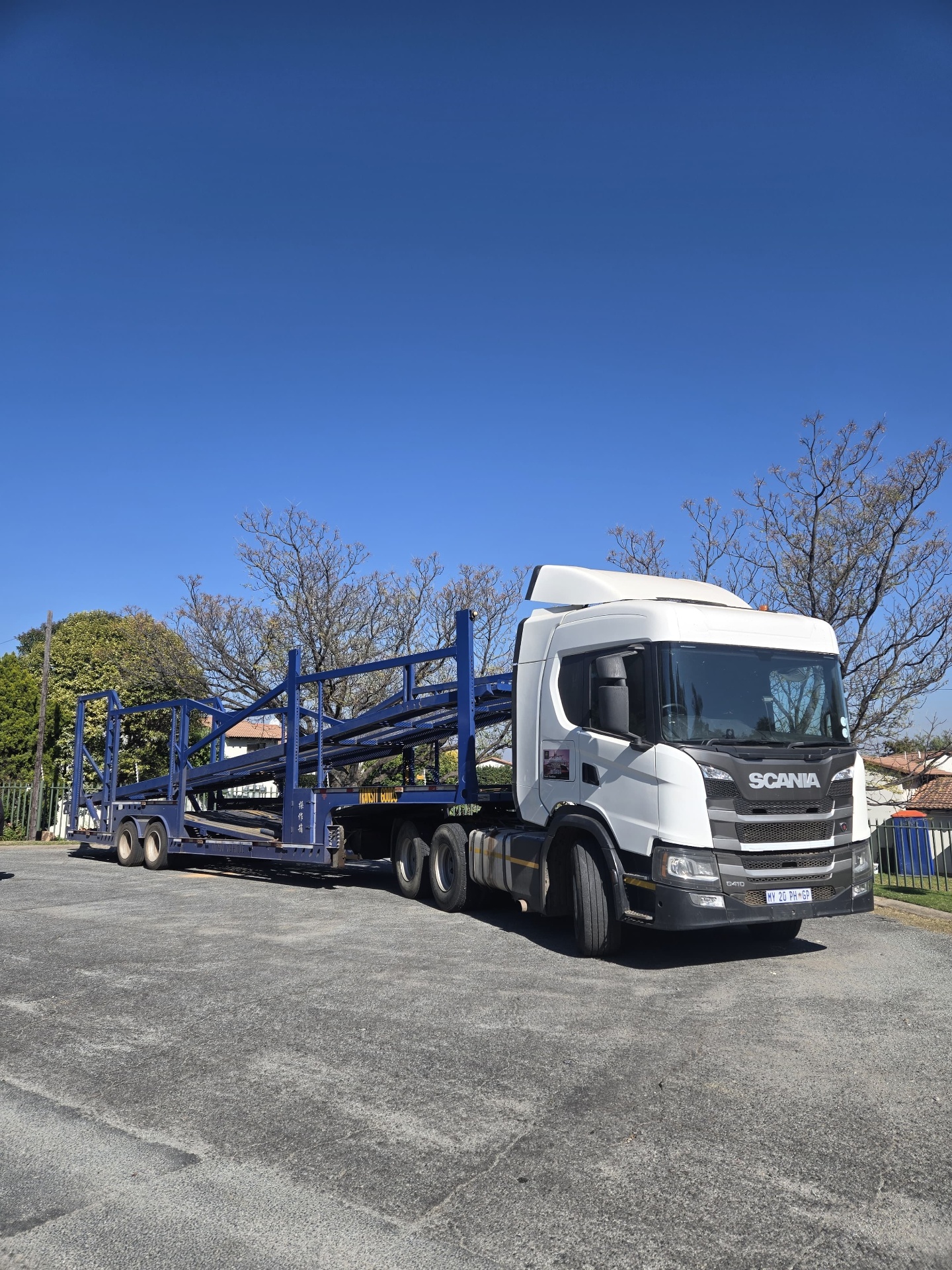 Scania G410 truck with a blue multi-car carrier trailer ready for vehicle transport