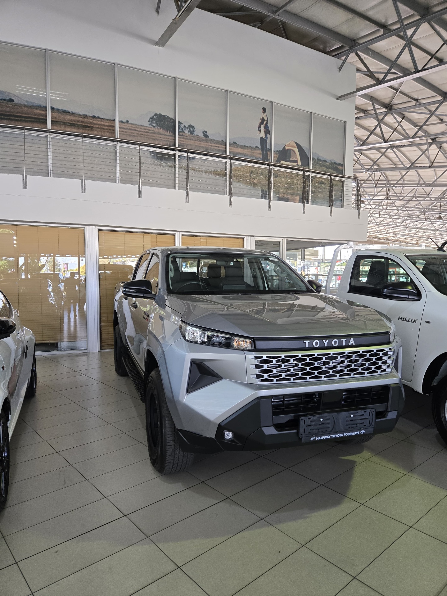 Grey Toyota Hilux double cab in the showroom
