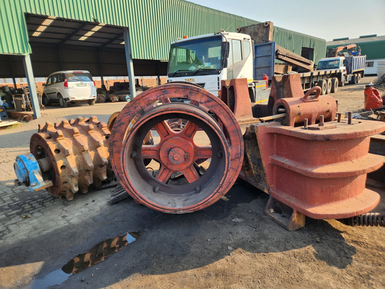Jaw crusher flywheel, toggle and crusher components in the yard